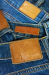 Pile Of Blue Jeans Closeup Label Stock Photo