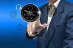 Man Touching Compass Stock Photo