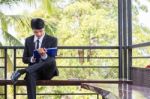 Young Businessman Looking At Report Paper Stock Photo