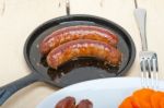 Beef Sausages Cooked On Iron Skillet Stock Photo