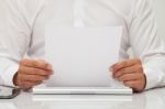 Man Holds Blank Sheet Of Paper In Hands Stock Photo