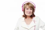 Senior Woman Listening To Music Stock Photo