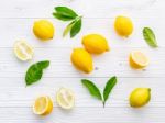 Fresh Lemons And  Lemons Leaves On White Wooden Background Stock Photo