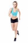 Young Lady Running In Sportswear Stock Photo