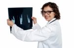 Female Doctor Reviewing X-ray Sheet Of A Patient Stock Photo