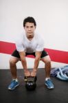 Young Man Lifting Kettlebell Stock Photo