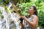 Girl Using Binoculars In Forest Stock Photo