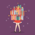 Santa Woman Holding A Pile Of Gift Boxes Stock Photo