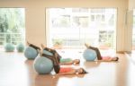 Asian Woman Doing Yoga Indoors Stock Photo