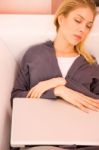 Young Woman Resting Sofa While Using Laptop Stock Photo