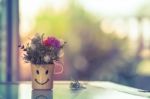 Bouquet Of Artificial Flowers On Happy Cup. Vintage Picture Style Stock Photo