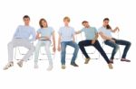 Teenagers Sitting On Chairs Stock Photo