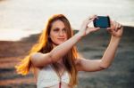 Girl With Smart Phone Near Beach Stock Photo