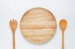 Wooden Plate With Spoon And Fork On White Background Stock Photo