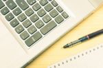 Silver Laptop And Notebook And Pen On Wood Table Vintage Style Stock Photo