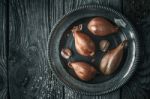 Shallot In The Metal Plate On The Wooden Table Top View Stock Photo