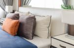 Modern Bedroom With Orange Pillow And Blue Blanket Stock Photo