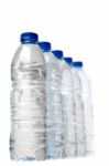 Row Of Plastic Water Bottles Isolated On A White Background Stock Photo