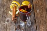 Mulled Wine And Spices On Weathered Wooden Table Stock Photo