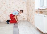 Handyman Laying Down Laminate Flooring Boards Stock Photo