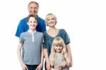 Cheerful Family Of Four Studio Portrait Stock Photo