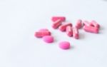 Pink Pills On White Stock Photo