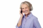 Senior Smiling Lady Attending Phone Call Stock Photo