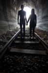 Couple Walking Together Through A Railway Tunnel Stock Photo