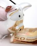 Saving Euros Cash In Piggy Bank Stock Photo