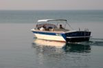 A Motorboat Slowing Cruising On Lake Garda Stock Photo