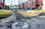 Sewer Hatch Building In New Road Stock Photo