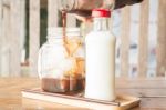 Pouring Espresso To Iced Glass Of Coffee Stock Photo