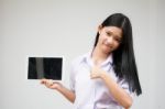 Portrait Of Thai High School Student Uniform Beautiful Girl Using Her Tablet Stock Photo