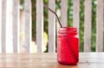 Iced Drink In Red Glass On Wooden Table Stock Photo