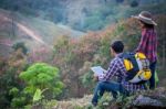 Tourists Look At A Map On The Tablet On Mountain Stock Photo