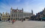 Bruges, Belgium - May 11, 2015: Tourist On Burg Square With City Stock Photo