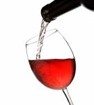 Wine Is Pouring From Bottle Into A Glass Isolated Stock Photo