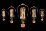 Incandescent Light Bulb On Black Background Stock Photo