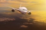 Traveling Plane Flying Over  Sun Rising Sky Stock Photo