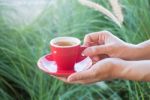 Woman Holds A Red Coffee Cup (vintage Style Color) Stock Photo