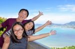 Family Of Tourists Inviting To See The Sea In Phuket, Thailand Stock Photo