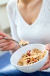 Beautiful Young Woman Eating Cereals At Home Stock Photo