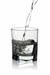 Water Pouring Into Glass With Its Reflection Isolated On White Stock Photo