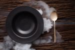 Black Empty Bowl Spoon On Wooden Table Background Stock Photo