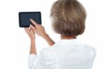 Mature Woman Using Tablet, From Back Stock Photo