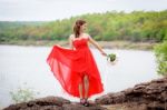 Beautiful Woman Wear Red Evening Dress Hold A Bouquet Of Flowers Stock Photo