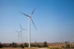 Windmill In Wind Farm With Blue Sky Stock Photo