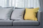 Yellow And Grey Pillows On Modern Sofa Stock Photo