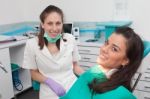 Dentist Examining A Patient's Teeth In The Dentist Stock Photo