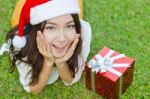 Santa Claus Hat With Red Christmas Gift Box Stock Photo